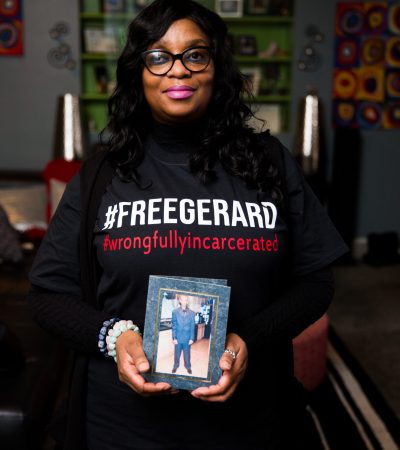 woman with image of wrongfully incarcerated man